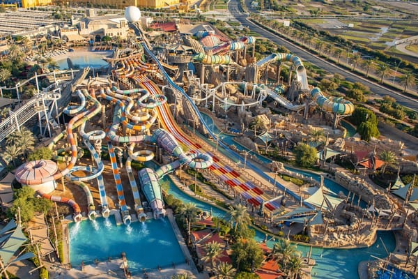 "Aerial view of Yas Waterworld Abu Dhabi, a vibrant water park with colorful slides and pools for thrilling family fun.