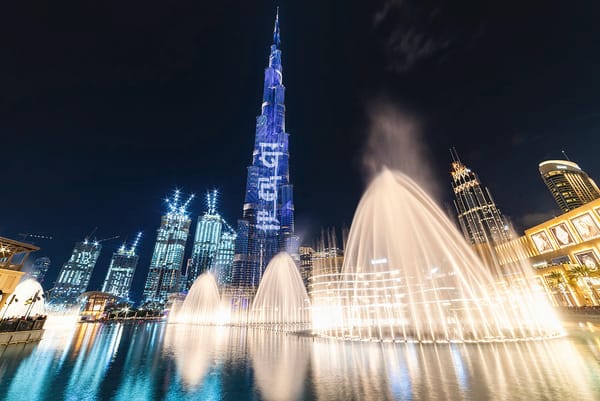 Dubai Fountain night show with water jets and Burj Khalifa in the background